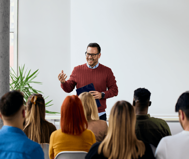 A man presenting for a group of professionals
