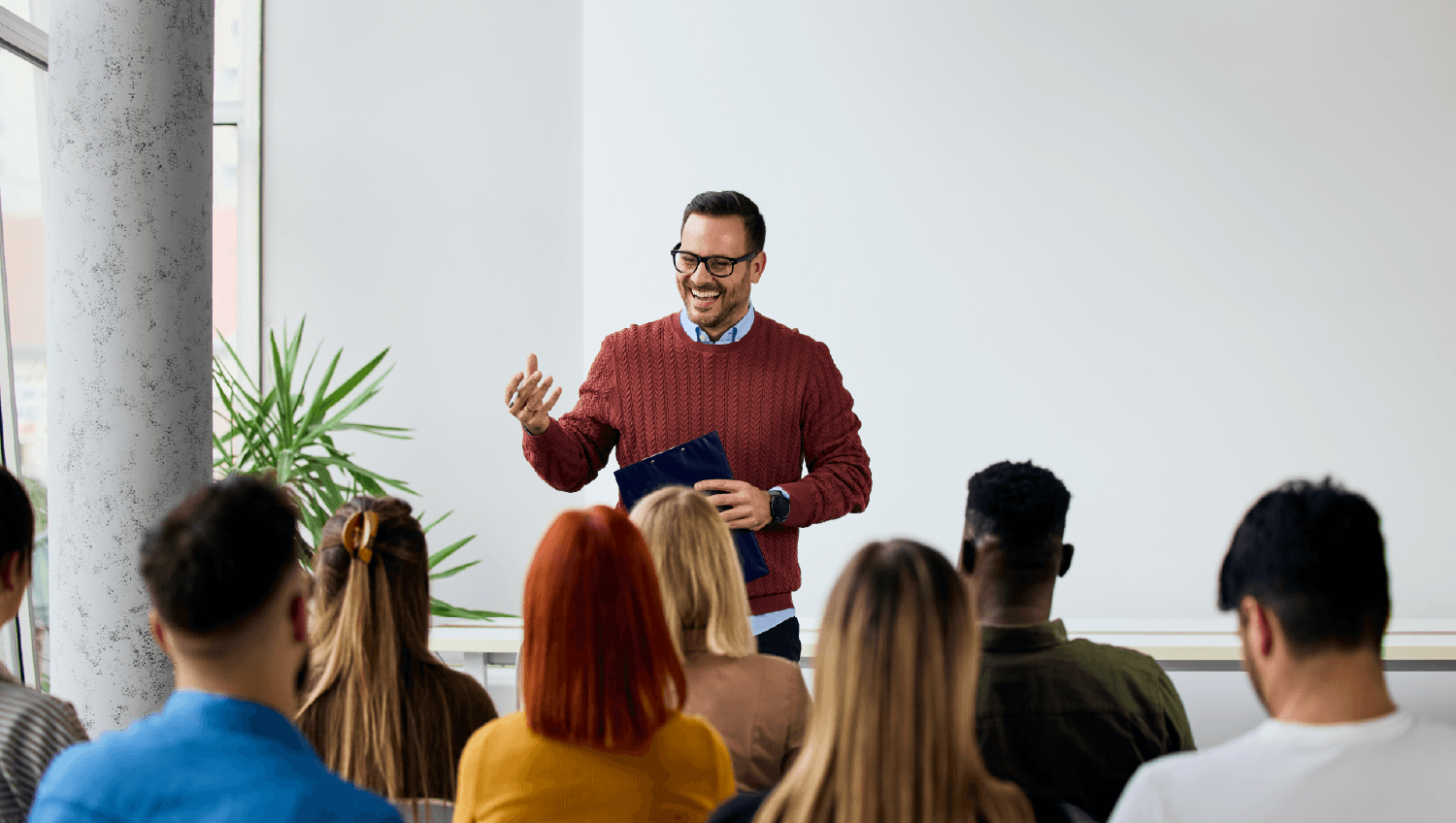 A man presenting for a group of professionals